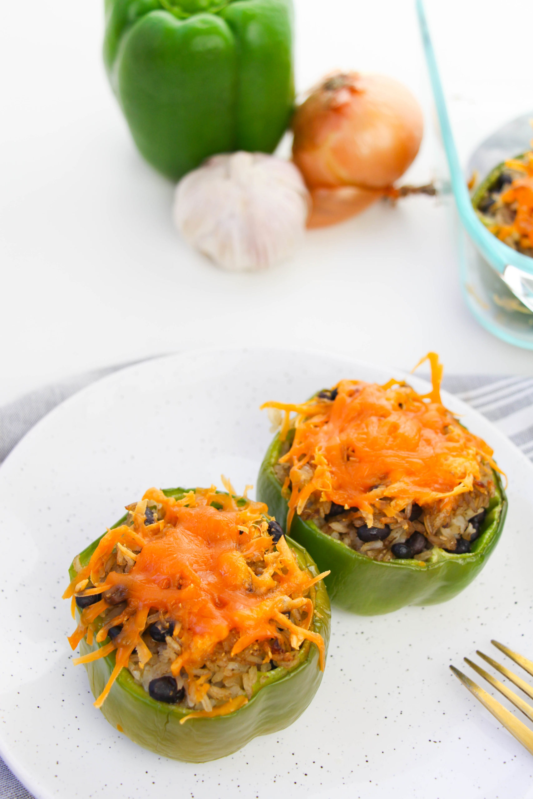 Two Black Bean Taco Stuffed Peppers on a white plate.