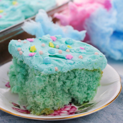 Side view of cotton candy cake on a white plate.