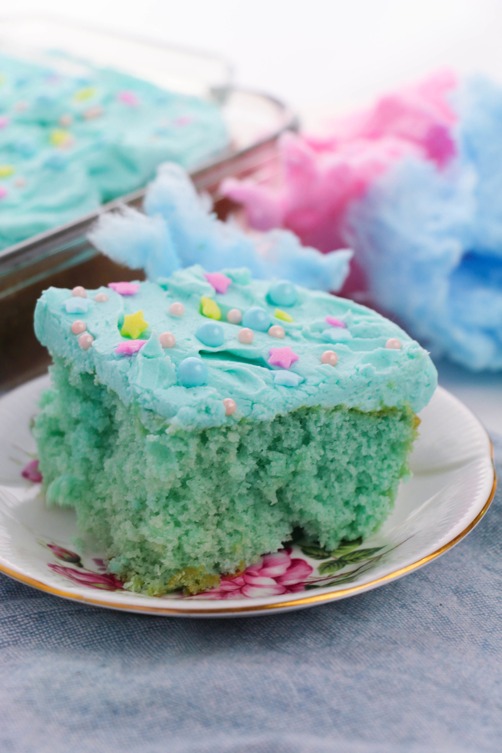 Side view of cotton candy cake on a white plate.