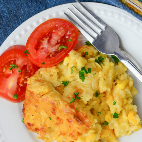 Creamy Cheese Corn Casserole with a side of tomatoes,
