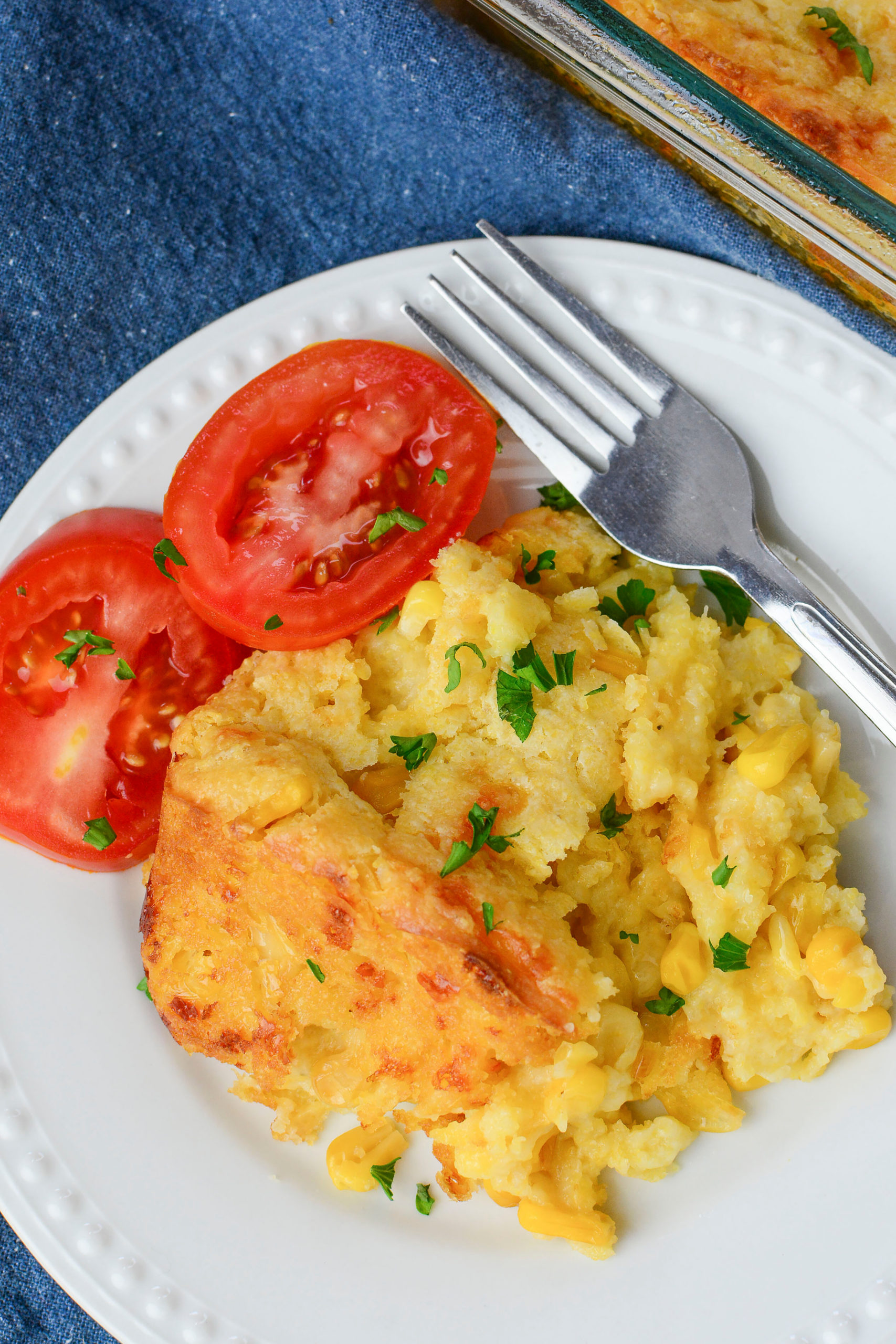  Creamy Cheese Corn Casserole with a side of tomatoes,