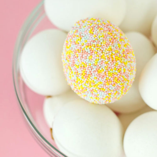Eggs covered in pastel covered sprinkles.