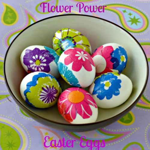 A bowl of easter eggs decorated with painted colorful flowers.