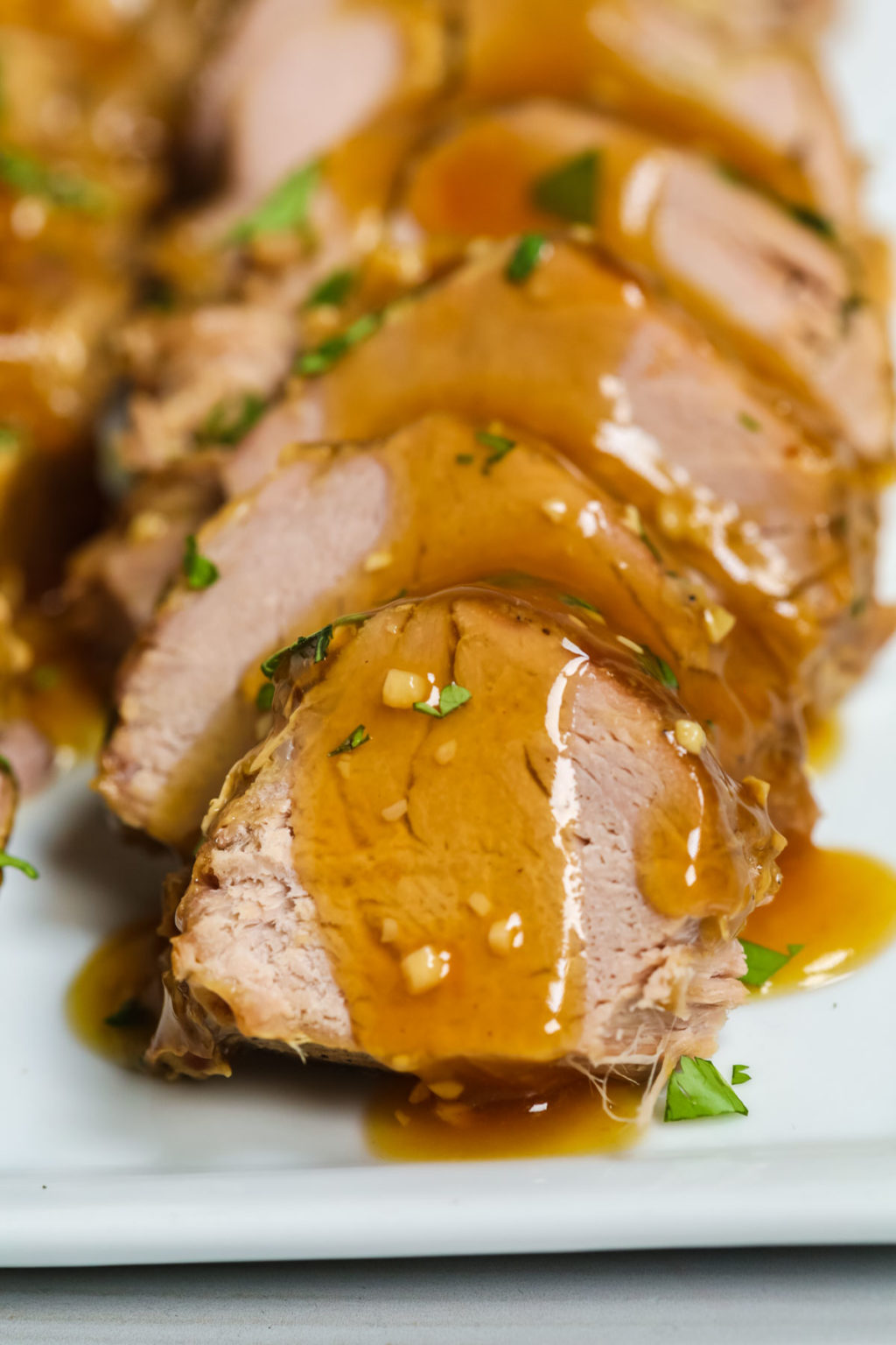 Garlic Crockpot Pork Tenderloin is an easy recipe that is fragrant and brings out the flavor of the tenderloin. Plus it has a wonderful sauce that is full of fresh garlic and has a sweet umami taste. This Garlic Crockpot Pork Tenderloin recipe cooks the meat low and slow and allows all the goodness to meld together and the meat becomes infused with the flavors. The best part is the slow cooker does all the work. Find even more crock pot recipes here? MORE PORK RECIPES YOU MIGHT LIKE Chipotle Pork Tenderloin Sliders| Mongolian Pork | Best Pork Chop Recipes What We Love About Pork Tenderloin Recipes Slow Cooker The pork was fall-apart tender and the sauce was thick, rich and velvety!&nbsp; It is so easy to put together, too.&nbsp; It takes no time at all to slow cook this tender meat and then produce an amazing pork tenderloin. Slow Cooker meal: Just brown it and let the slow cooker do all the work, it is one of the best easy dinner recipes.Easy Ingredients: All found in pantry or fridge for slow cooking an amazing pork tenderloin. Family Friendly: Juicy tender pork tenderloin is always a comfort food hit with the whole family.Makes Great Leftovers: Leftovers make great sandwiches the next day or warm on medium high heat on the stovetop. Ingredient Notes for this Slow Cooker Tenderloin Extra Virgin Olive OilBoneless Pork TenderloinSalt and Black pepper to taste or use House Seasoning Blend.Garlic, finely mincedReduced-sodium Soy SauceChicken Broth or Chicken StockLight Brown SugarRed Pepper Flake or Onion Powder and Garlic PowderCornstarch Equipment Needed to Slow Cook a Pork Tenderloin Slow CookerSaucepanMeasuring CupsMeasuring Spoons How to Make Pork Tenderloin in the Crock Pot These are the basic steps for making&nbsp;slow cooker pork tenderloin recipe.&nbsp;Please refer to the recipe card below for more detailed instructions.