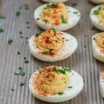 A platter of the appetizer garnished with paprika and chopped chives.