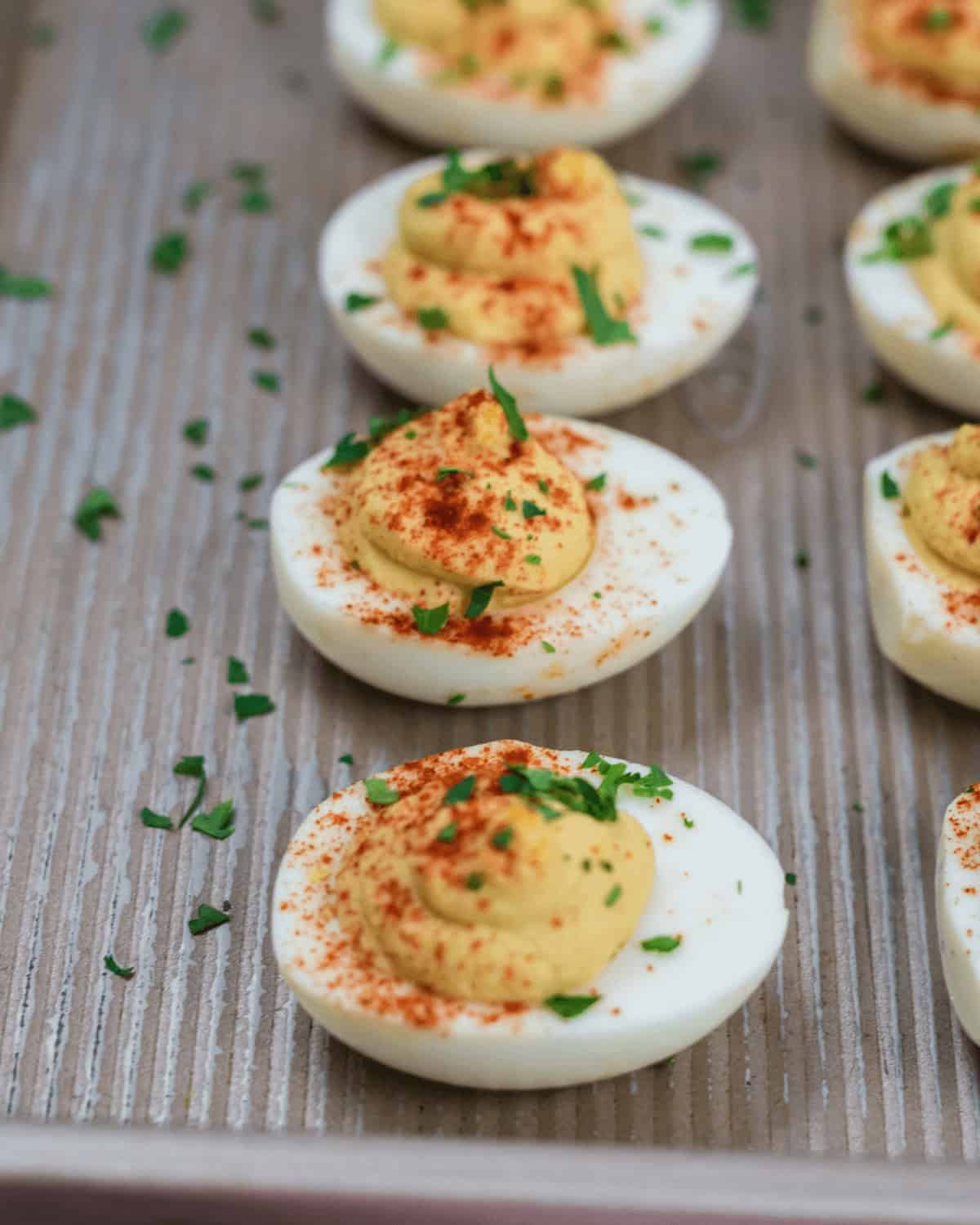 A platter of the appetizer garnished with paprika and chopped chives.