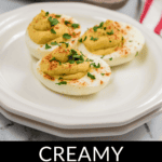 Plate of Million Dollar Deviled Eggs garnished with paprika and parsley.