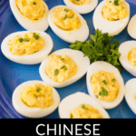 Plate of shrimp deviled eggs garnished with parsley, displayed on a blue plate.