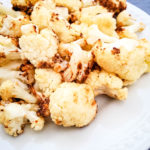 cauliflower after air frying on a white plate