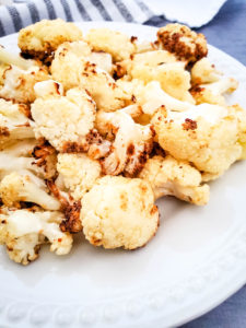 cauliflower after air frying on a white plate