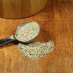 All Purpose Seasoning on a wooden table in a measuring spoon.