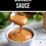 A spoon pours creamy, pepper-flecked sauce into a small white ramekin, perfectly capturing the essence of the best burger sauce.