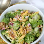 broccoli bacon salad in a white bowl.
