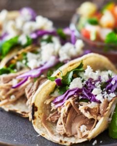 Carnitas Pulled Pork Tacos on a slate plate.