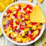 Mango salsa with a chip in it.