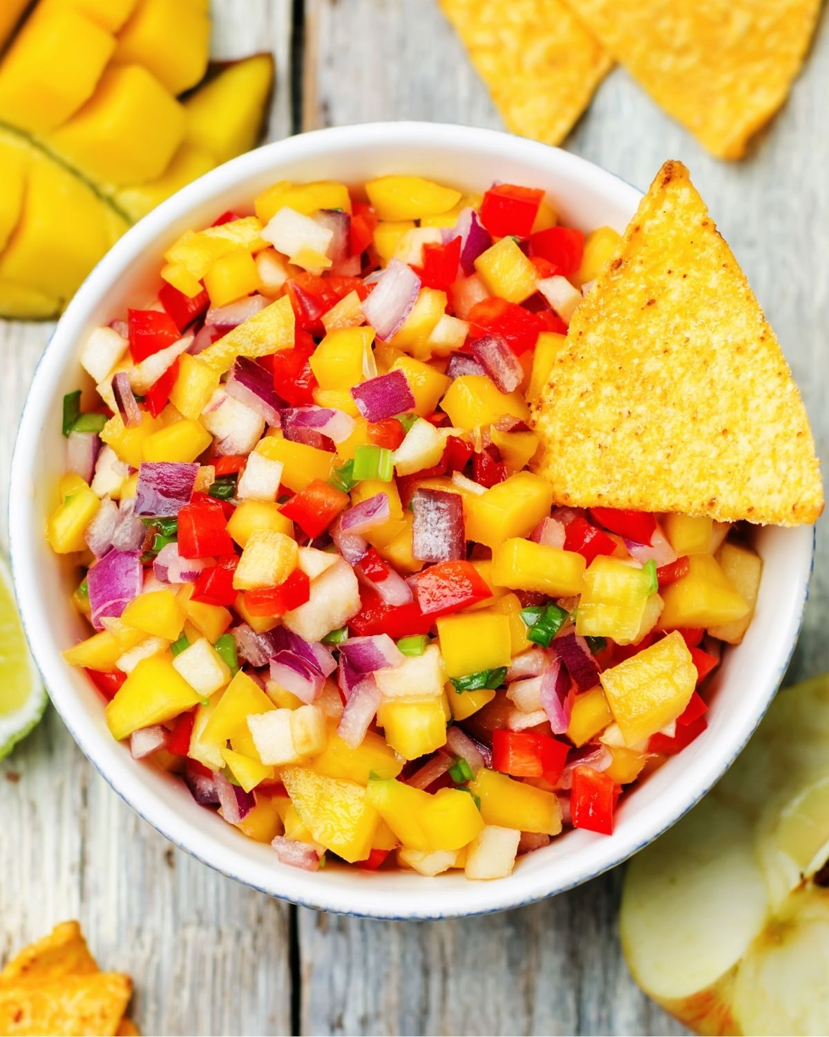 Mango salsa with a chip in it.