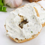 A bagel with cream cheese on it.