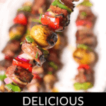 A close-up shot of succulent steak kabobs sizzling on the grill, with vibrant vegetables threaded on skewers. The text at the bottom reads, "Delicious Grilled Steak Kabobs.