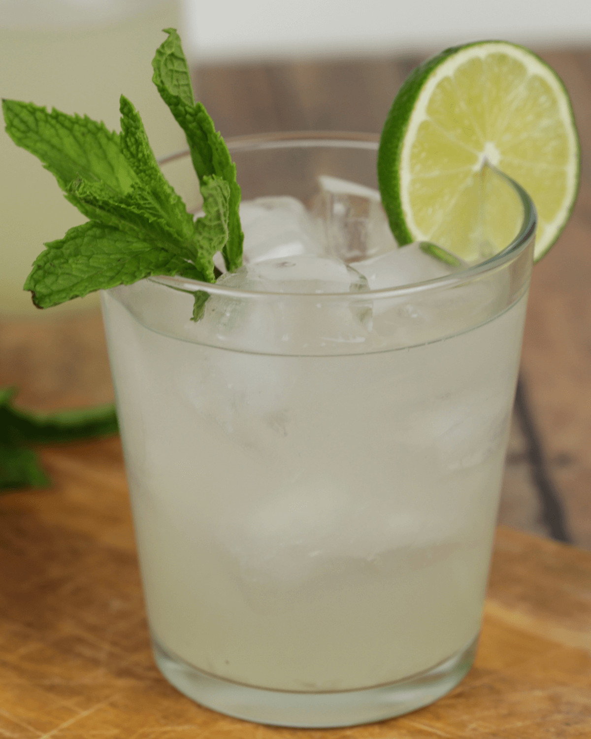 A glass of moonshine mojito garnished with fresh mint and a lime wedge.