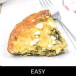 A slice of spinach frittata with feta rests invitingly on a white plate, accompanied by a fork—an appetizing glimpse into a delightful Spinach Frittata Recipe.
