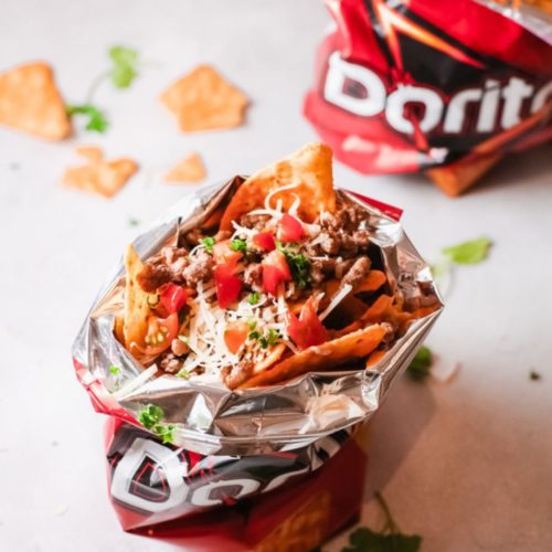 Taco in a bag with broken Doritos scattered
