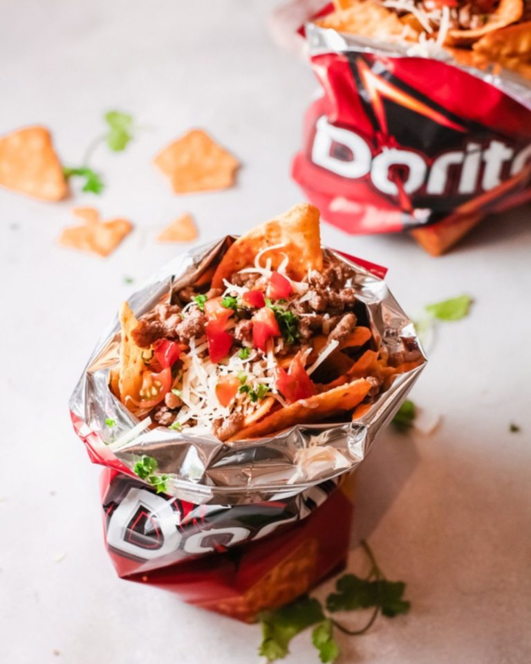 Taco in a bag with broken Doritos scattered