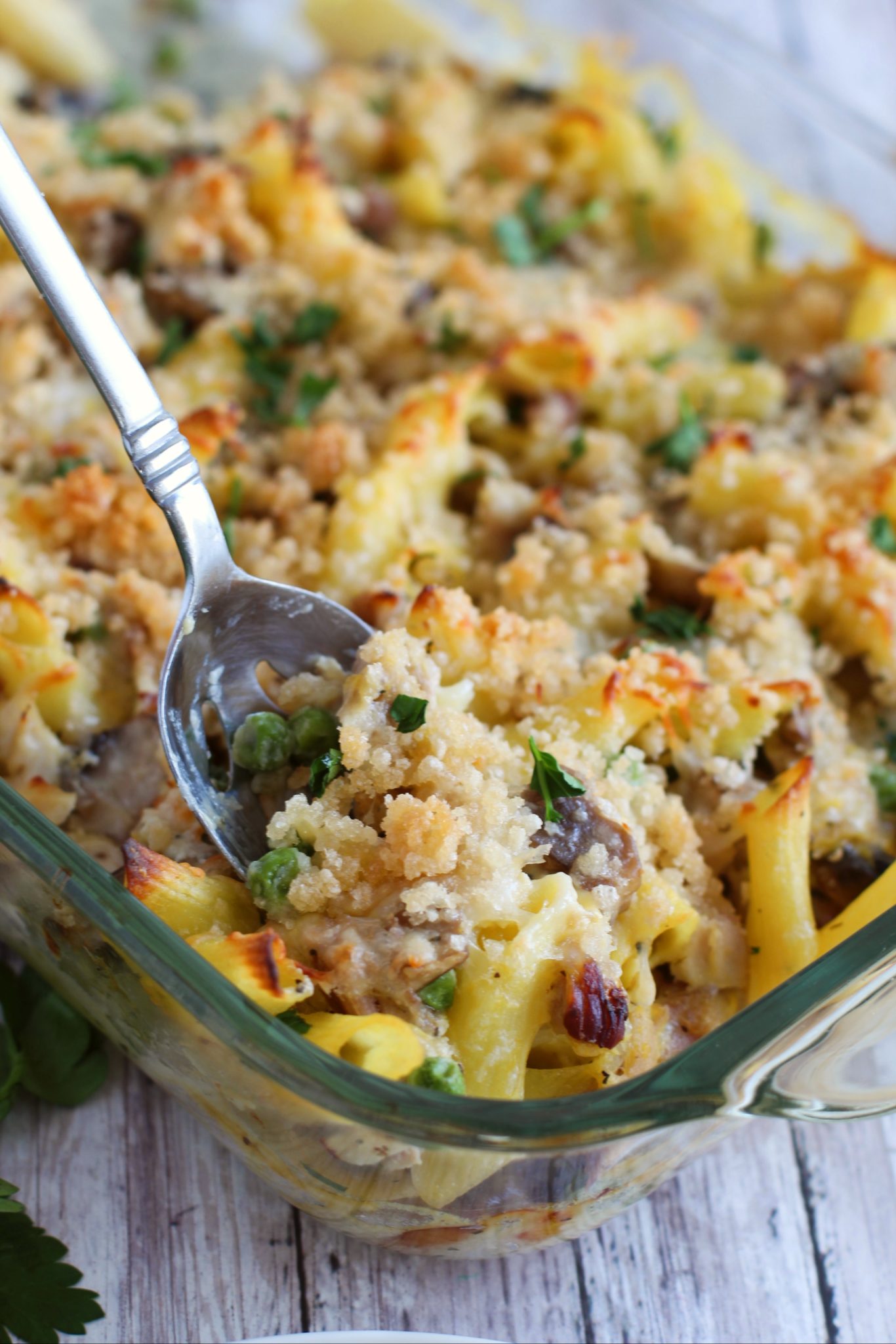 A spoon in a glass casserole dish of the turkey casserole.