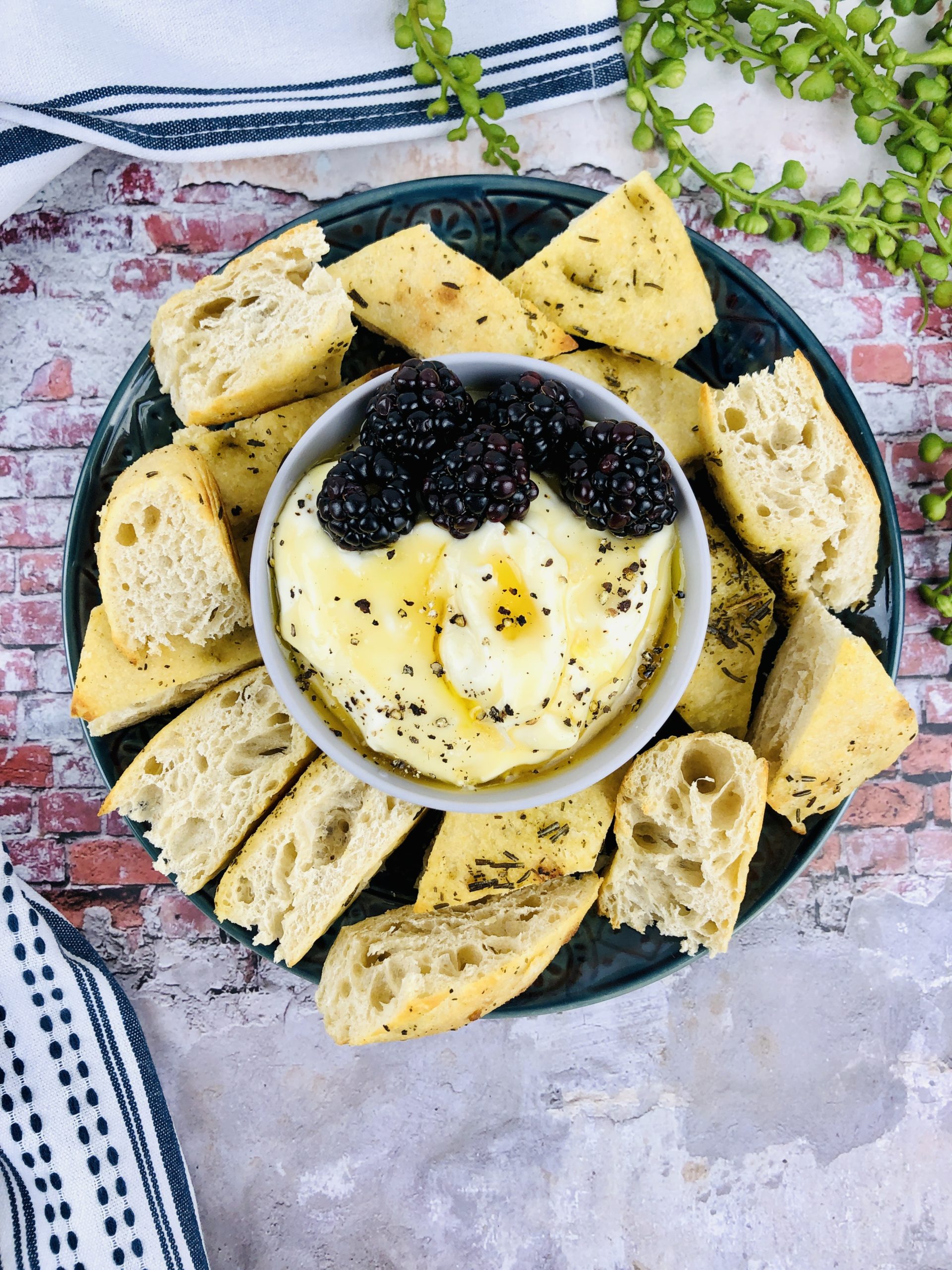 Whipped Ricotta Dip with Honey in a top shot surrounded by crusty bread.
