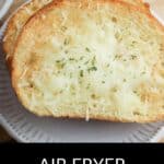 Two slices of Air Fryer Garlic Bread with melted cheese and herbs on a white plate, with the text "AIR FRYER GARLIC BREAD" below the image.