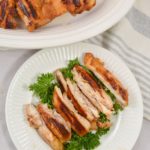 Slices of chicken on a white plate.