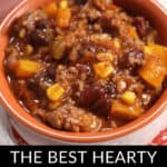 A bowl of hearty beef and bean chili with vegetables, served on a white plate with a red placemat. Text at the bottom reads: "The Best Beef and Bean Chili.