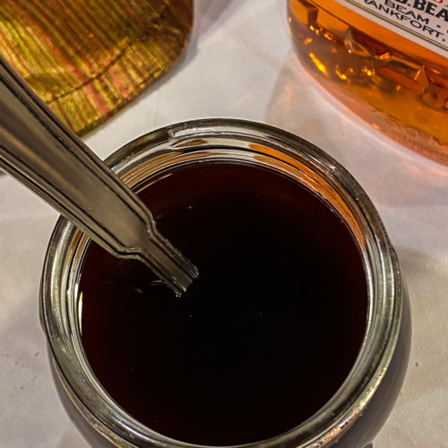 Bourbon Glaze in a mason jar with a spoon.