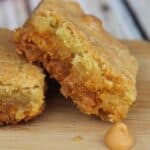 Two cookies with a chip beside them.