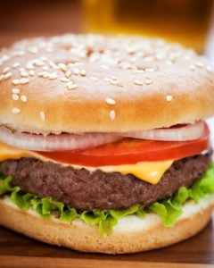 Cast Iron Burgers with lettuce, tomato and onion.