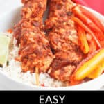 A bowl of rice topped with two savory Oven Chicken Kabobs and sliced bell peppers. Text at the bottom reads "Easy Chipotle Oven Chicken Kabobs.