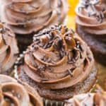 Chocolate whipped cream frosting with sprinkles on top.