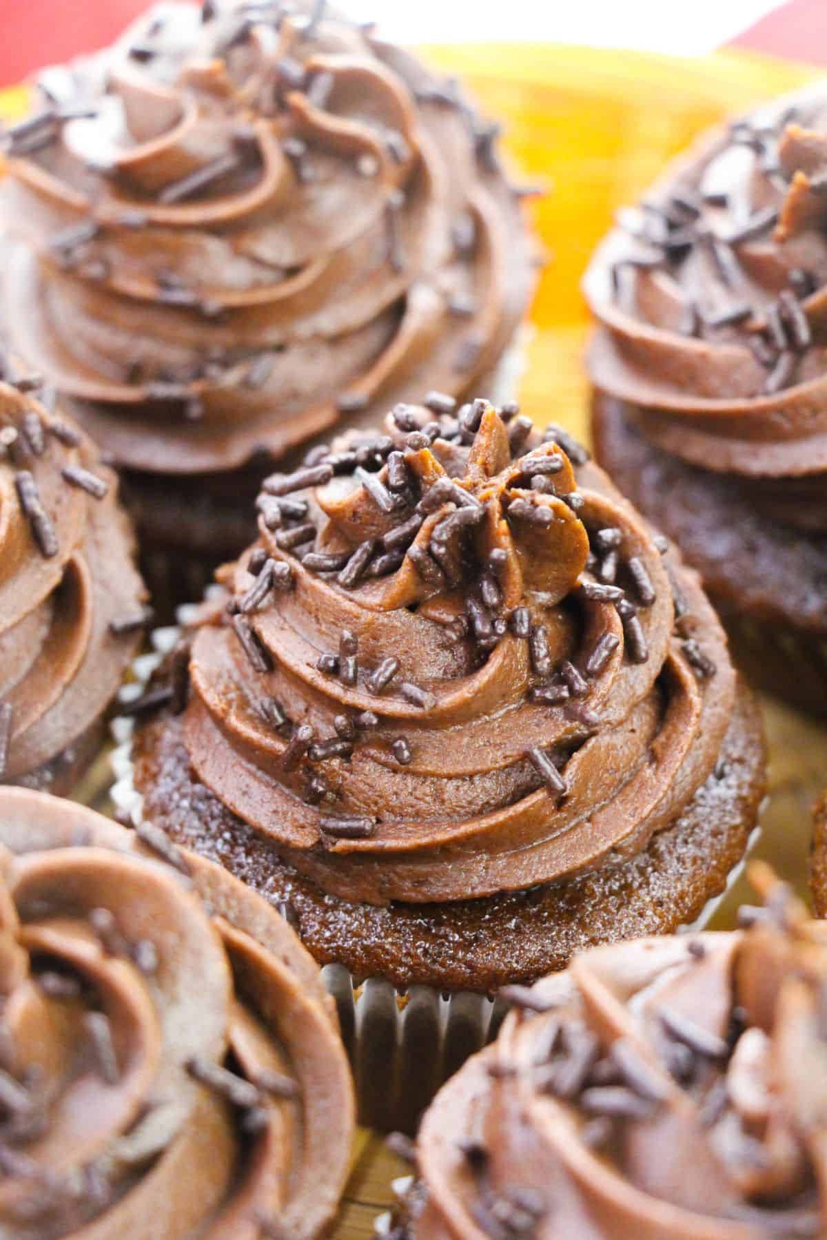 Chocolate whipped cream frosting with sprinkles on top.