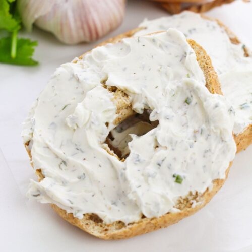 The garlic and herb spread on a bagel.