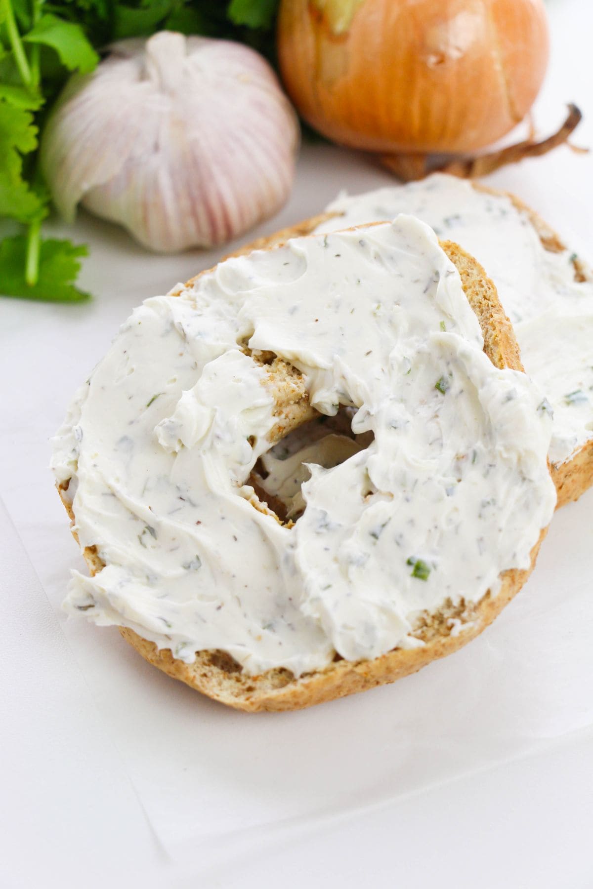 The garlic and herb spread on a bagel.