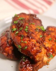 Instant Pot barbecue chicken on a white plate with a striped napkin