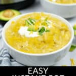 Two bowls of Instant Pot Chicken Enchiladas topped with cheese, sour cream, and cilantro are placed on a table. An Instant Pot is visible in the background. Text at the bottom reads "Easy Instant Pot Chicken Enchiladas.
