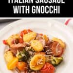 A plate of Italian Sausage with Gnocchi, cherry tomatoes, broccoli, and bell peppers, all topped with shredded cheese.