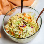 A fork in a bowl of slaw.