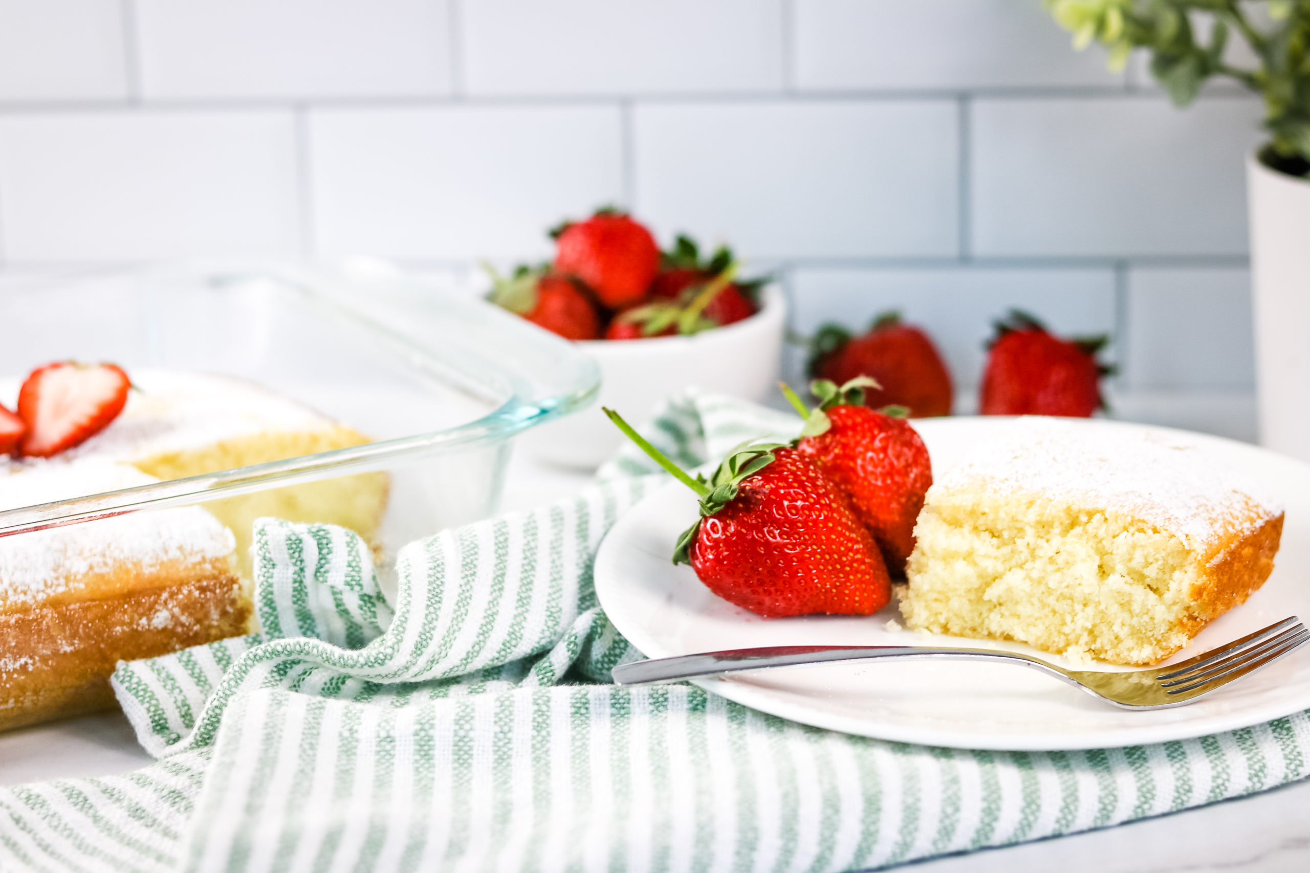 Lazy Cake with a bowl of strawberries.