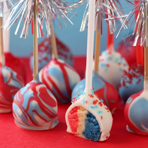 Red white and blue cake pops on a red plate