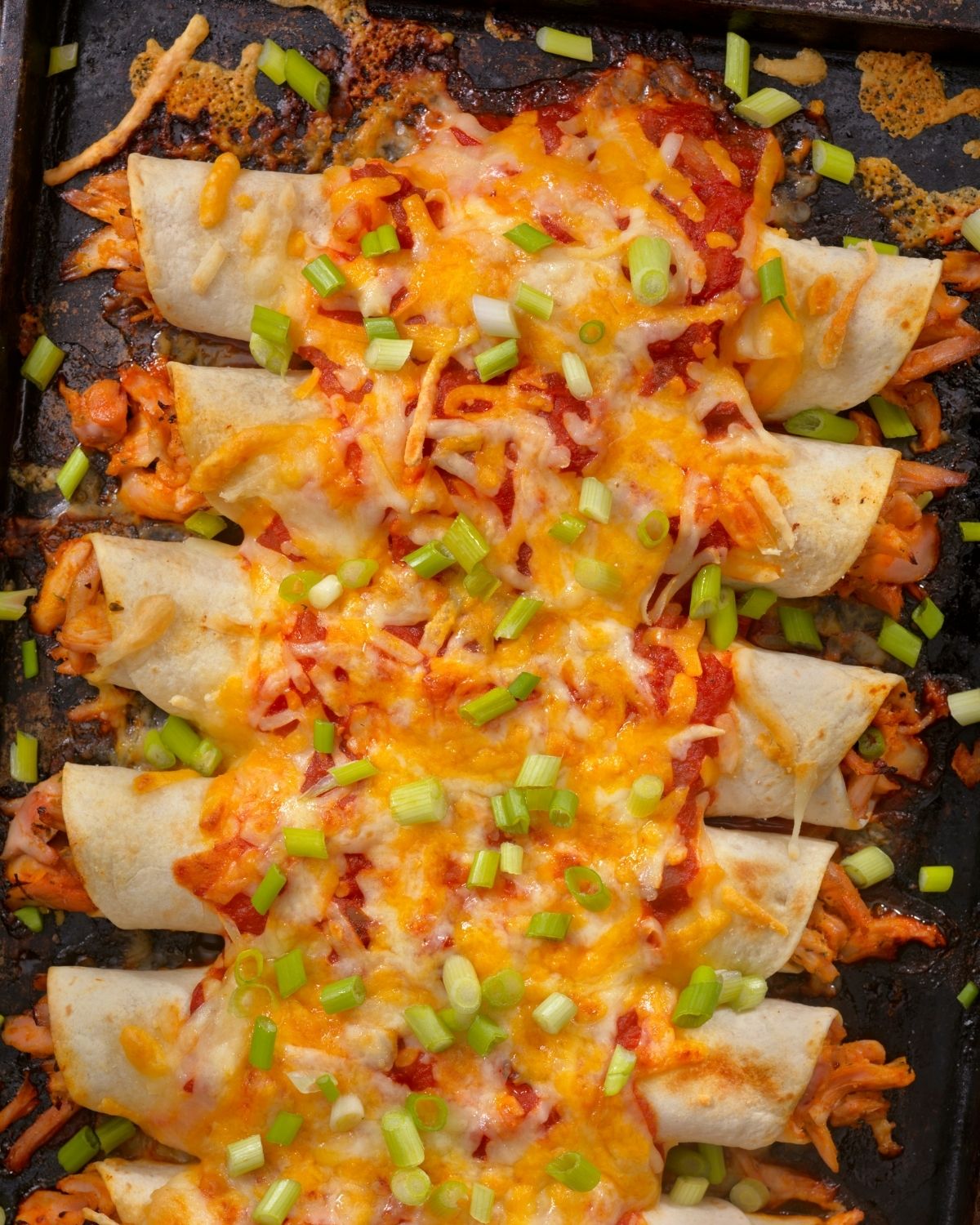 a full tray of chicken enchiladas.