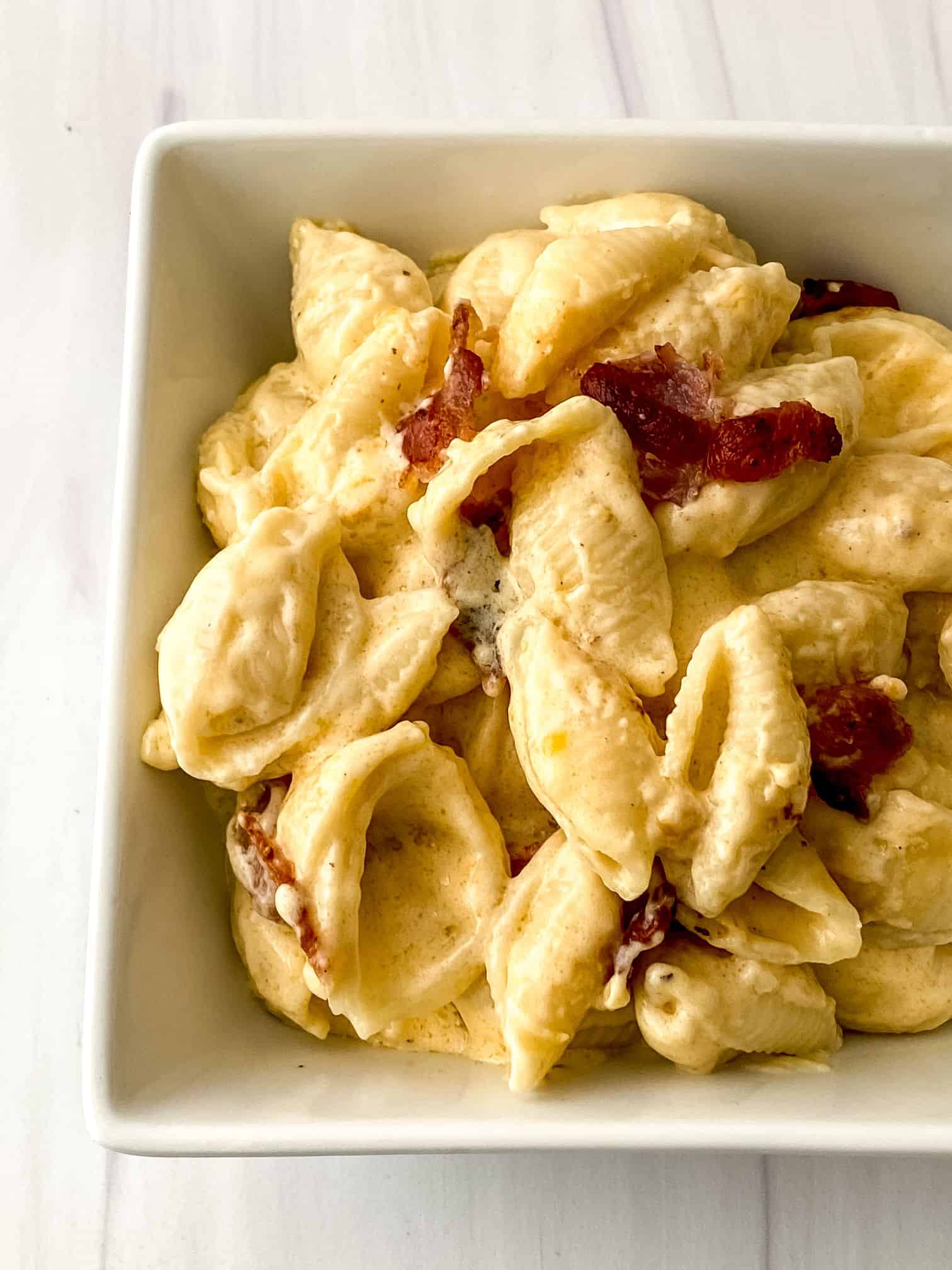 A square dish with bacon mac and cheese.