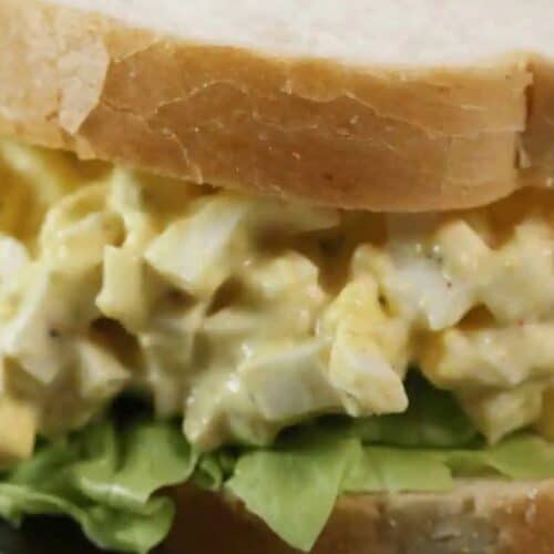 Enjoy an easy egg salad sandwich with crisp lettuce, all nestled between slices of soft white bread.