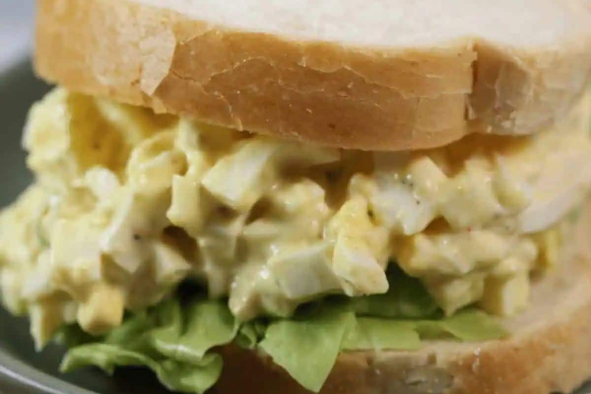 Enjoy an easy egg salad sandwich with crisp lettuce, all nestled between slices of soft white bread.