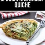 A slice of Spinach and Bacon Quiche rests on a white plate with a fork, set atop a striped cloth napkin.